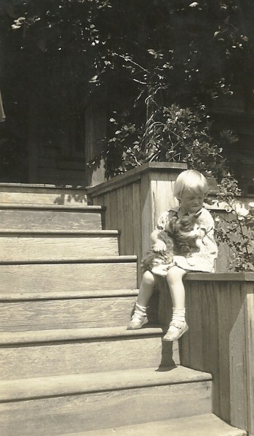 My mother, as a child, on the same steps holding a cat.