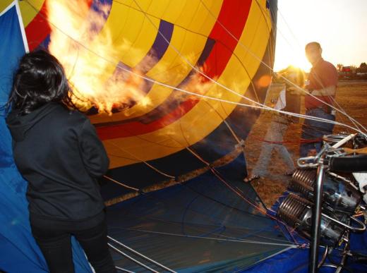 Heating the air in the balloon.