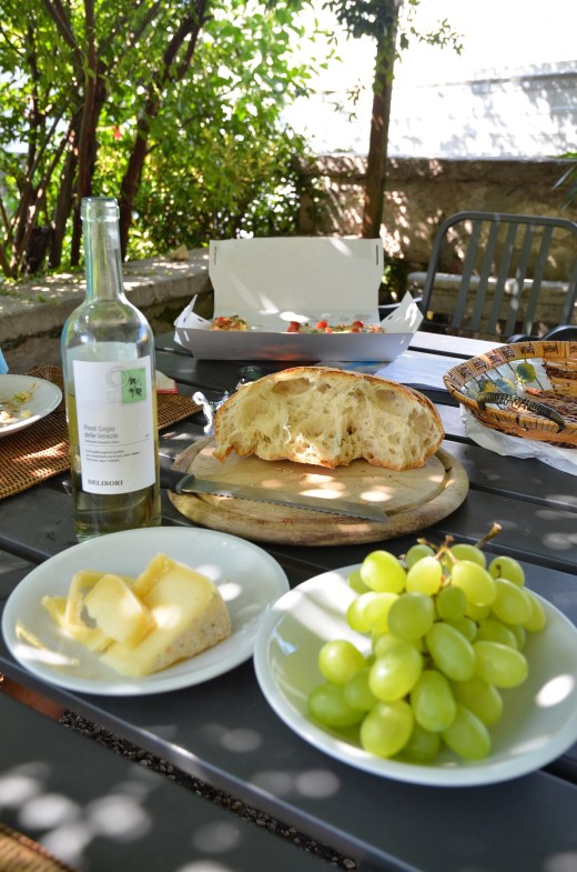 Lunch of local wine, cheese, grapes and pizza
