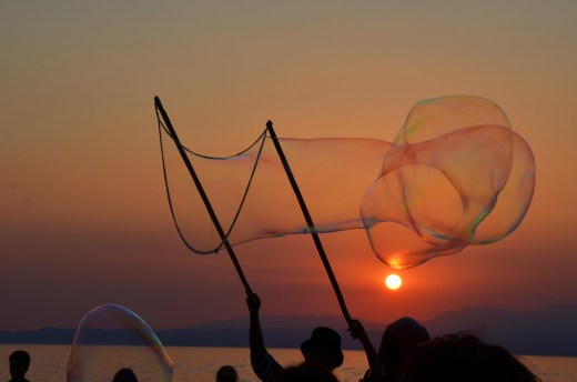 A street performer along the waterfront at sunset