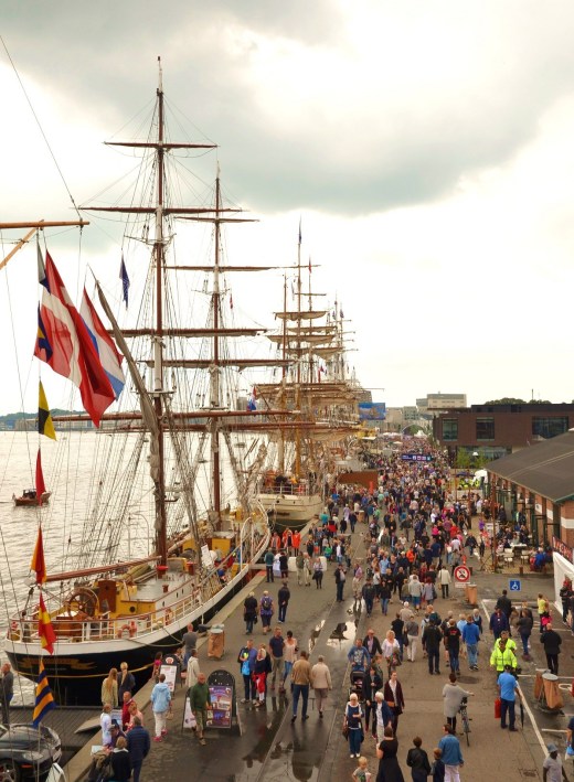 Ships and people crowd the port in Aalborg